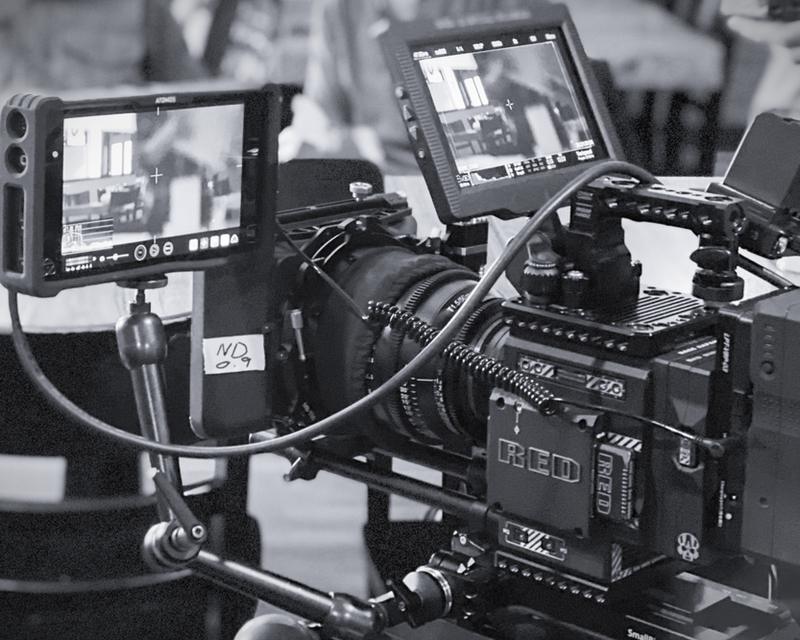 Cinema camera rig with monitors on set.